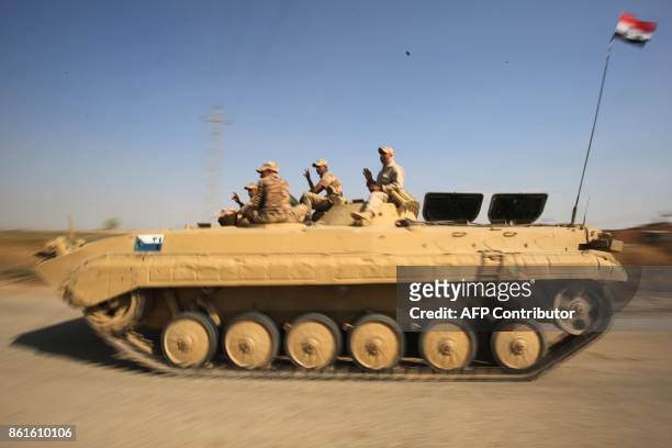 Iraqi forces drive towards Kurdish peshmerga positions on October 15 on the southern outskirts of Kirkuk. The presidents of Iraq and Iraqi Kurdistan...
