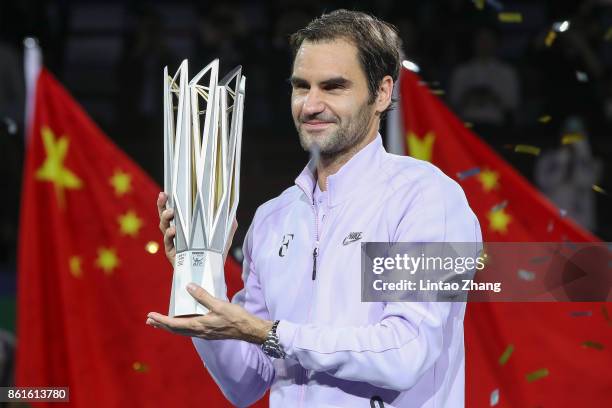 Roger Federer of Switzerland poses with the winner's trophy after defeating Rafael Nadal of Spain during the Men's singles final mach on day eight of...