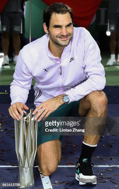 Roger Federer of Switzerland poses with the winner's trophy after defeating Rafael Nadal of Spain during the Men's singles final mach on day eight of...