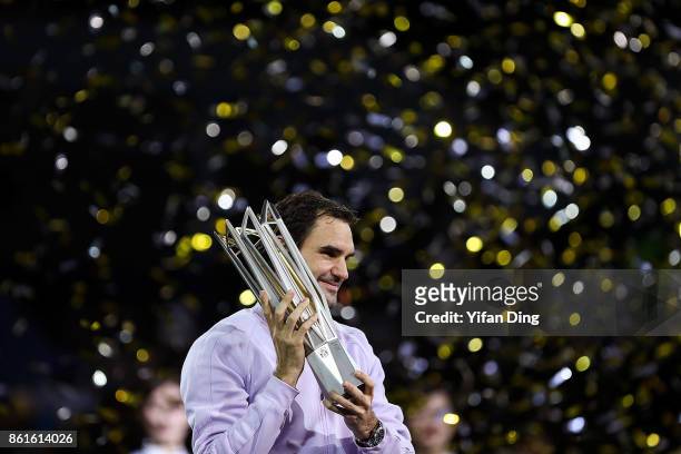 Roger Federer of Switzerland poses with the trophy during the award ceremony after winning his Men's singles final match against Rafael Nadal of...