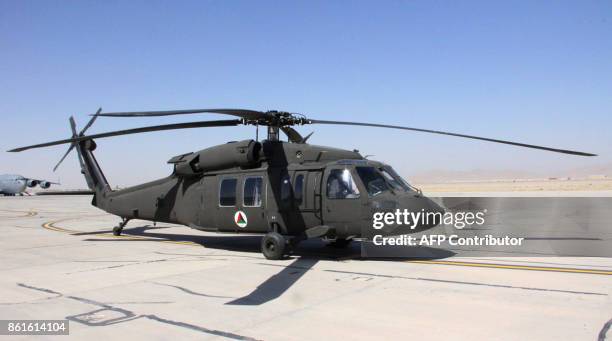 An Afghan air force UH-60 Black Hawk helicopter sits at Kandahar Airfield in Afghanistan on September 28, 2017. Parked at a military runway in...