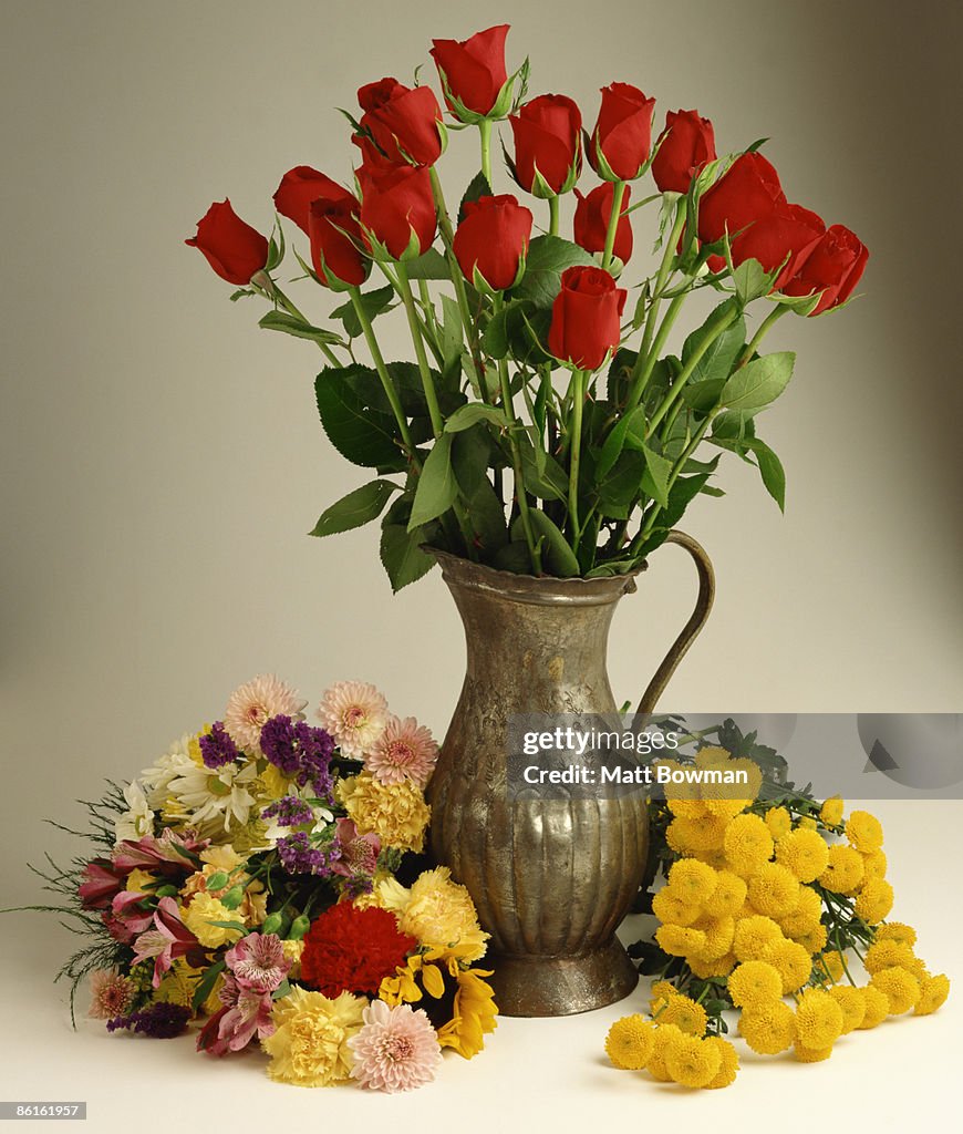 Vase of roses with assorted flowers