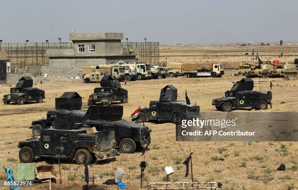 Iraqi forces gather in the area of Taza Khurmata on the southern outskirts of Kirkuk on October 15, 2017. The presidents of Iraq and Iraqi Kurdistan...