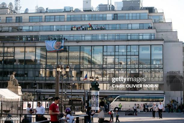 Kurdish people wave flags and banners picturing jailed Kurdish leader Abdullah Ocalan as they take part in a demonstration on the balconies, after...