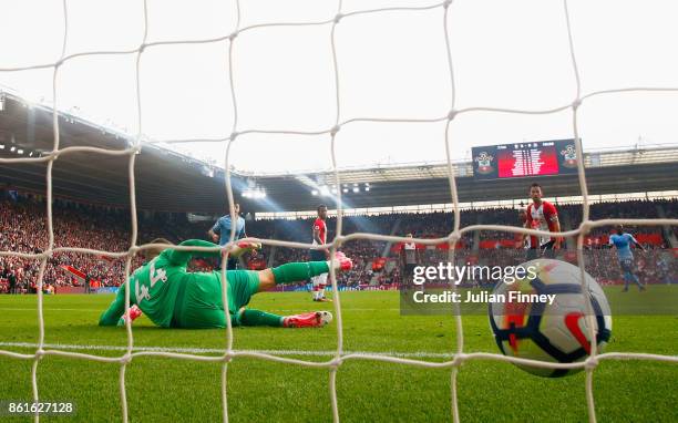 Goalkeeper Fraser Forster of Southampton fails to stop Isaac Hayden of Newcastle United from scoring their first goal during the Premier League match...