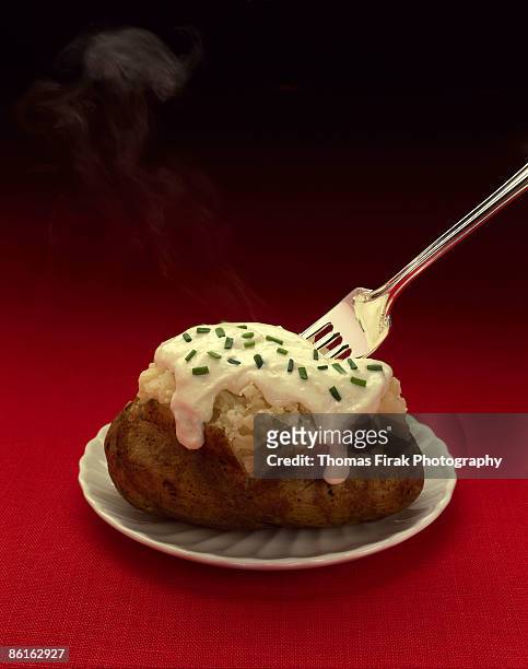 baked potato with sour cream and chives -  firak stock pictures, royalty-free photos & images