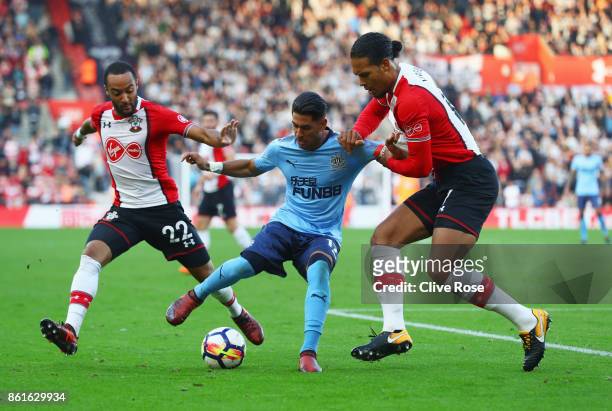 Ayoze Perez of Newcastle United battles with Nathan Redmond and Virgil van Dijk of Southampton during the Premier League match between Southampton...