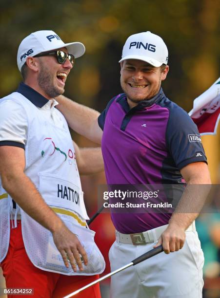 Tyrrell Hatton of England celebrates holeing the winning putt with his caddie Jonathan during the final round of The Italian Open at Golf Club Milano...