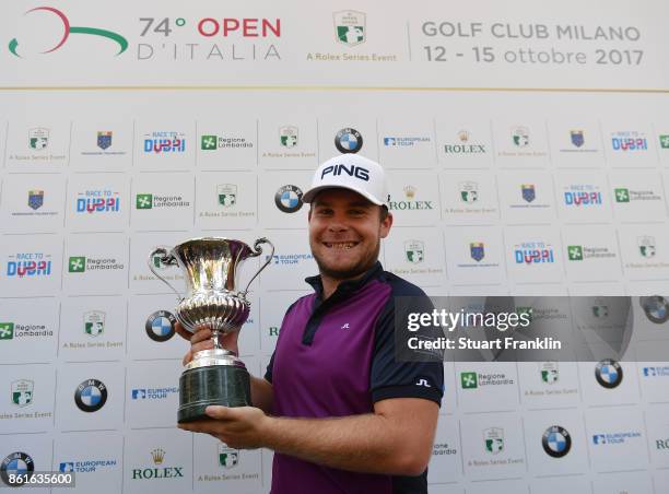 Tyrrell Hatton of England holds the winners trophy after winning The Italian Open at Golf Club Milano - Parco Reale di Monza on October 15, 2017 in...