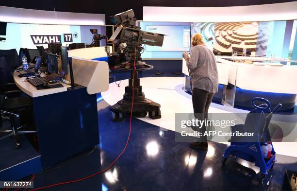 Woman cleans the floor of a public television studio in Hanover on October 15 ahead of the television debate on the election results of the...