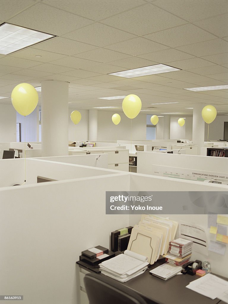 Empty office with yellow balloons