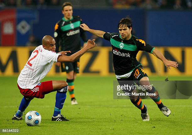 Alex Silva of Hamburg and Diego of Bremen battle for the ball during the DFB Cup Semi Final match between Hamburger SV and SV Werder Bremen at the...