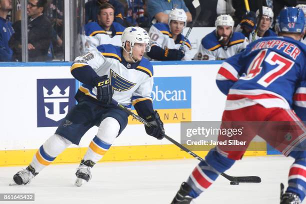 Ivan Barbashev of the St. Louis Blues skates with the puck against Steven Kampfer of the New York Rangers at Madison Square Garden on October 10,...