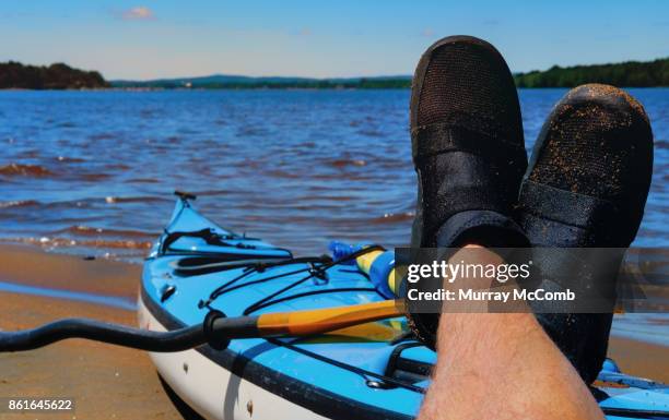 senior male paddler enjoying a kayak adventure - murray mccomb stock pictures, royalty-free photos & images