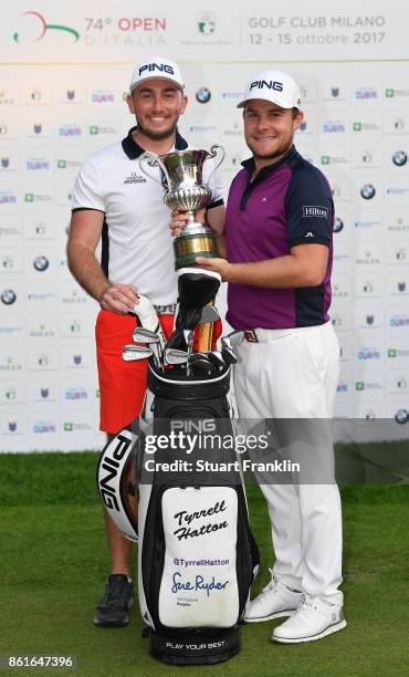 Tyrrell Hatton of England holds the winners trophy with his caddie Johnathan Bell after the final round of The Italian Open at Golf Club Milano -...