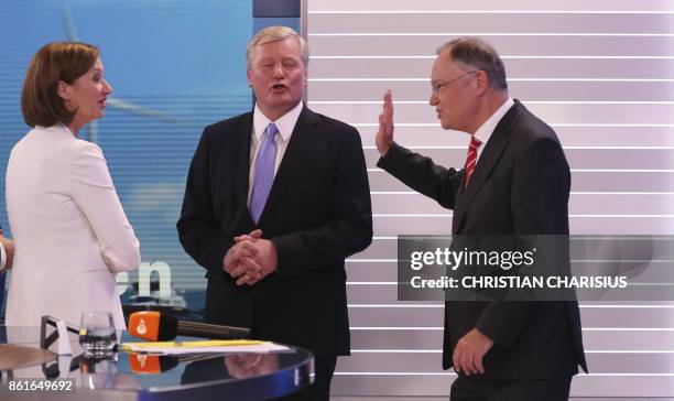 Lower Saxony's State Premier Stephan Weil of the Social democratic SPD party waves to Bernd Althusmann , top candidate of the conservative Christian...