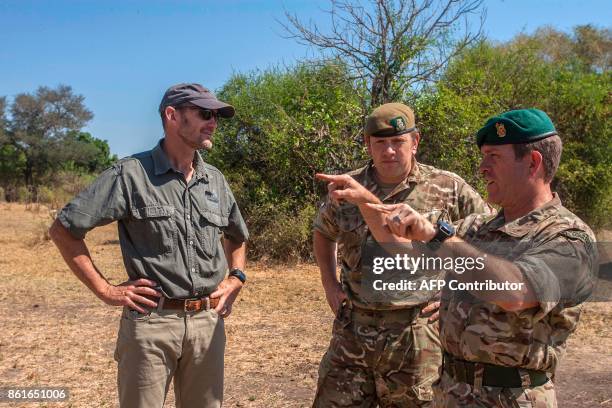 Defence Attache for British High Commission in Malawi, Royal Marines Commando Colonel Mike Geldard gestures as he speaks with British Major, Counter...