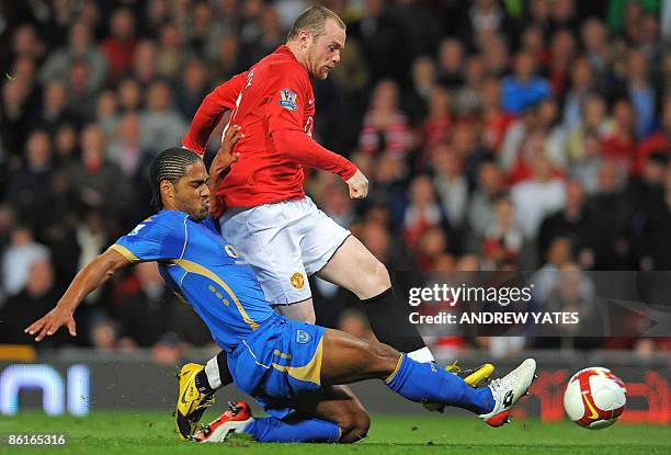 Manchester United's English forward Wayne Rooney vies with Portsmouth's English defender Glen Johnson during their English Premiership football match...