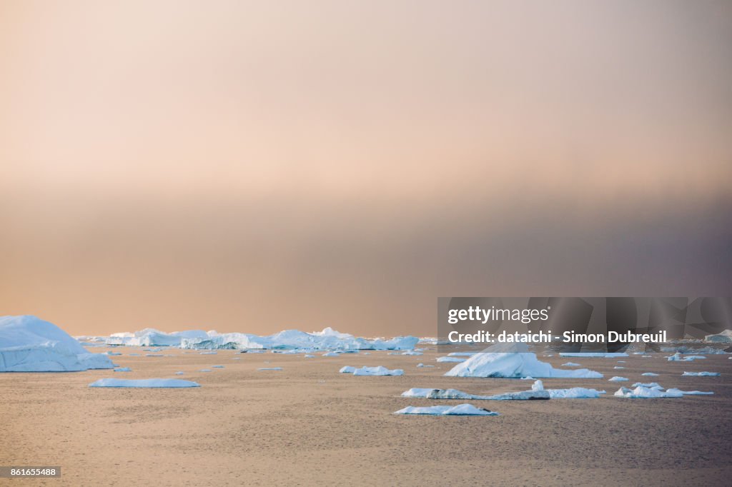 Sunset on the icebergs of Ilulissat Icefjord