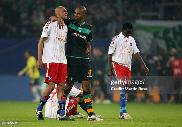Naldo of Bremen comforts Alex Silva of Hamburg after the DFB Cup Semi Final match between Hamburger SV and SV Werder Bremen at the HSH Nordbank Arena...