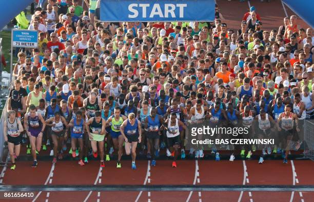 People compete in the Amsterdam Marathon in Amsterdam on October 15, 2017. Cherono won the race in 2:05:09, setting a course record and taking one...