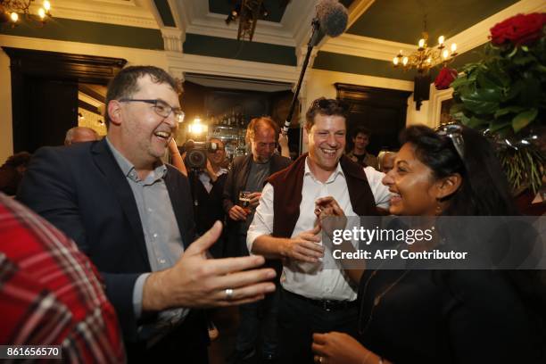 Groen's Wouter Van Besien, SP.A's Tom Meeuws and Police commissary Jinnih Beels celebrate at a press conference of the local branches of Flemish...