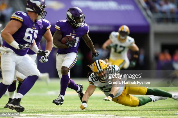 Jerick McKinnon of the Minnesota Vikings, breaks a tackle by Clay Matthews of the Green Bay Packers for a 27 yard touchdown reception during the...
