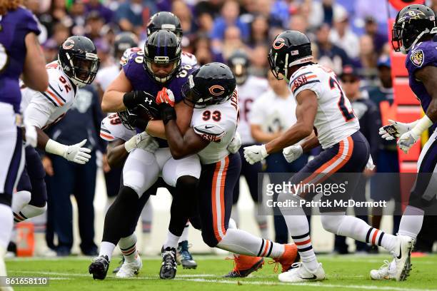 Tight End Nick Boyle of the Baltimore Ravens is tackled by outside linebacker Sam Acho of the Chicago Bears in the first quarter at M&T Bank Stadium...
