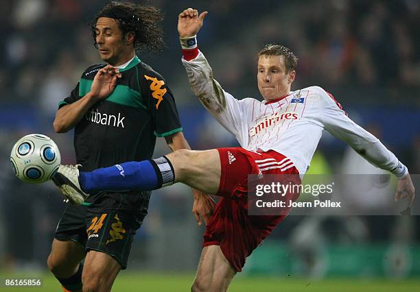 Marcell Jansen of Hamburg and Claudio Pizarro of Bremen battle for the ball during the DFB Cup Semi Final match between Hamburger SV and SV Werder...