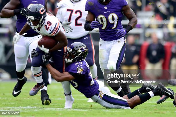 Running Back Tarik Cohen of the Chicago Bears carries the ball against Marlon Humphrey of the Baltimore Ravens in the first quarter at M&T Bank...