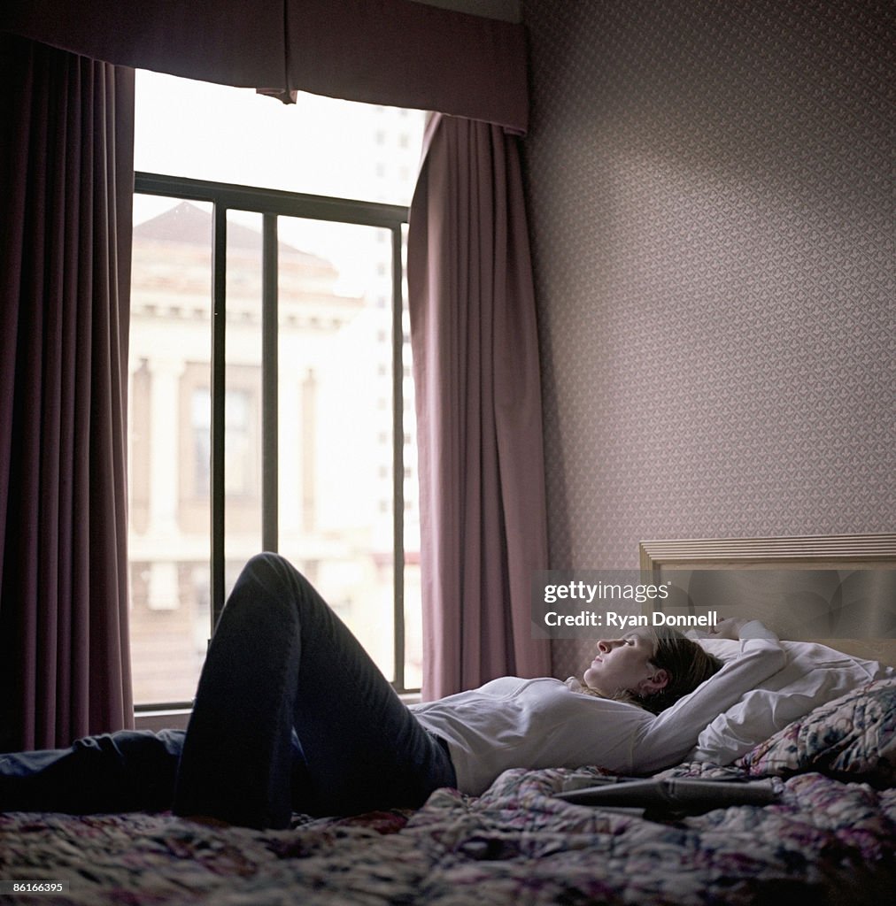 Woman lying on bed