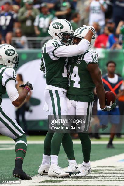 Wide receiver Jeremy Kerley of the New York Jets celebrates his 31-yard touchdown with teammate Jermaine Kearse against the New England Patriots...