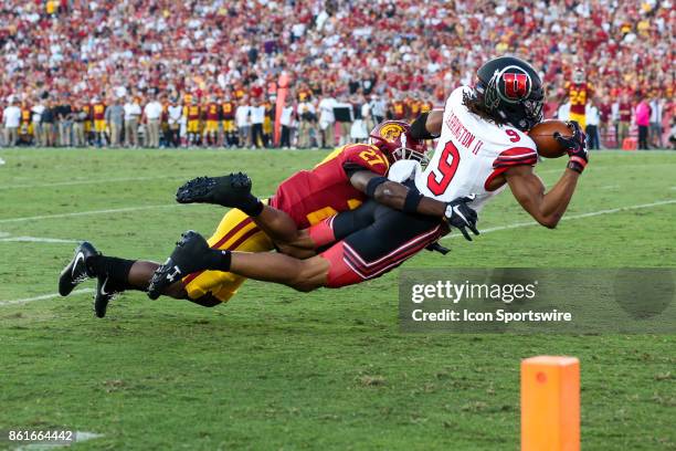 Wide receiver Darren Carrington II of the Utah Utes drops pass while being defended by cornerback Iman Marshall of the USC Trojans in a game between...