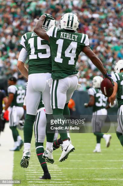 Wide receiver Jeremy Kerley of the New York Jets celebrates his 31-yard touchdown with teammate quarterback Josh McCown against the New England...