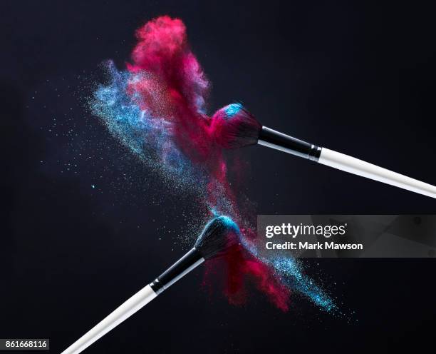 make up brushes with red and blue powder - colour explosion stock pictures, royalty-free photos & images