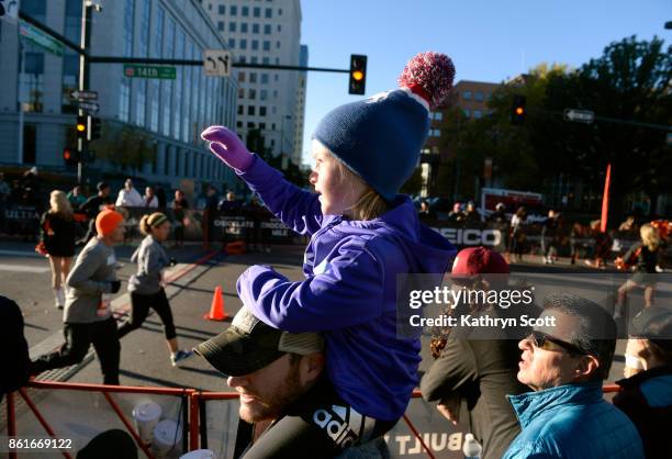 Atop her dad Patrick's shoulders, Lyla Cuin looks for her mom Emily to pass them near the finish line of the 8th annual Transamerica Rock n' Roll...