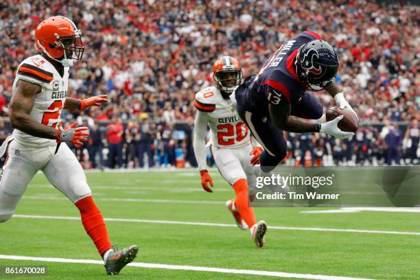 Braxton Miller of the Houston Texans dives into the endzone for a touchdown in the second quarter defended by Jamar Taylor of the Cleveland Browns at...