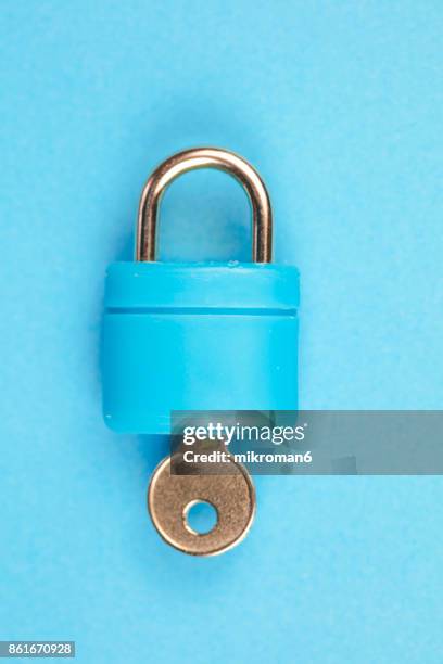 blue padlock with key on blue background - unlocking stock pictures, royalty-free photos & images