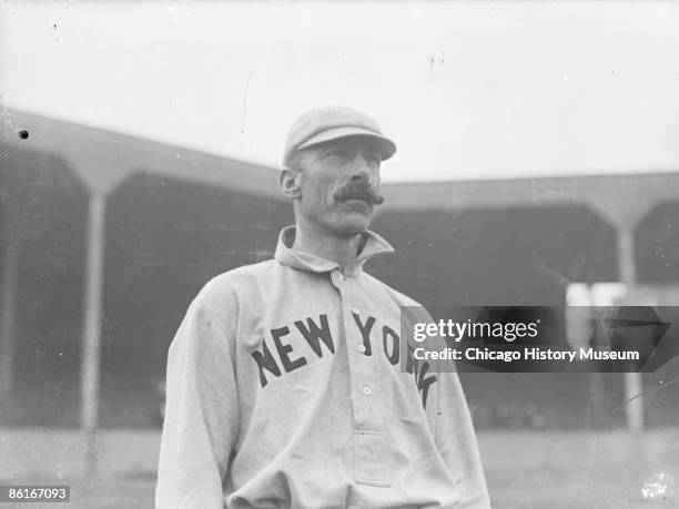 Half-length portrait of George Van Haltren, outfielder for the New York Giants, National League baseball team, standing on the field near grandstand...