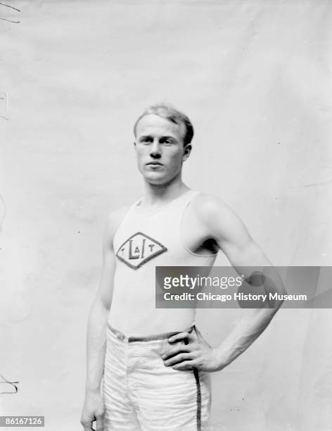 Half length portrait of athlete, William Hogenson, silver medalist in the 60 meter dash during the 1904 Summer Olympics, standing in a stairwell...