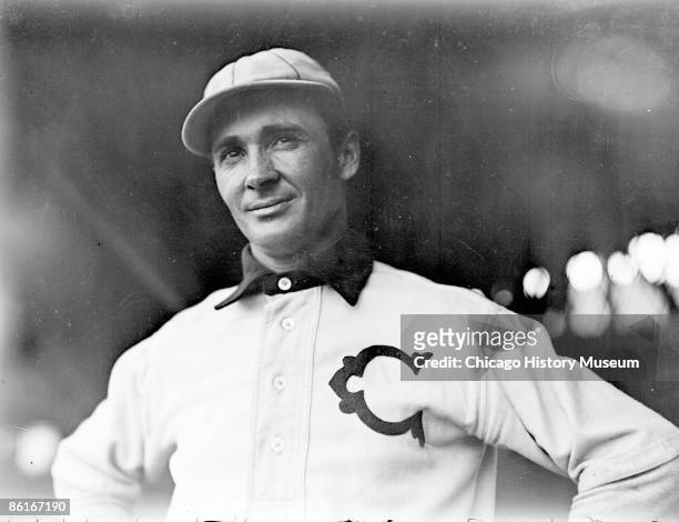 Half-length portrait of Ducky Holmes, left fielder for the for the Chicago White Sox, American League, standing by grandstand concourse netting at...