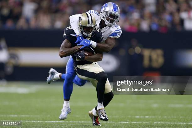 Hayden of the Detroit Lions tackles Ted Ginn of the New Orleans Saints during the first half of a game at the Mercedes-Benz Superdome on October 15,...