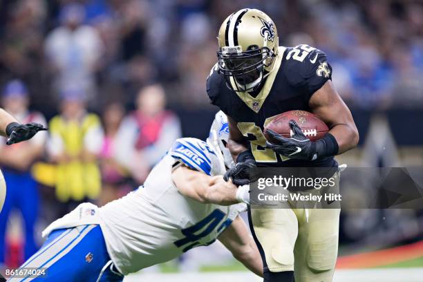 Mark Ingram II of the New Orleans Saints runs the ball for a touchdown against Nick Bellore of the Detroit Lions at Mercedes-Benz Superdome on...