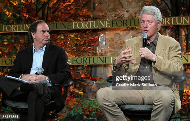 Managing editor of Fortune magazine Andy Serwer and former President Bill Clinton speak on stage at the Fortune Brainstorm Green conference at the...