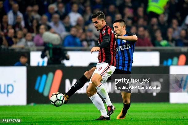 Inter Milan's Uruguayan midfielder Matias Vecino vies with AC Milan's Portuguese forward Andre Silva during the Italian Serie A football match Inter...