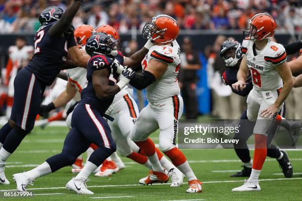 Lamarr Houston of the Houston Texans and Joe Thomas of the Cleveland Browns fight for the line in the second quarter at NRG Stadium on October 15,...