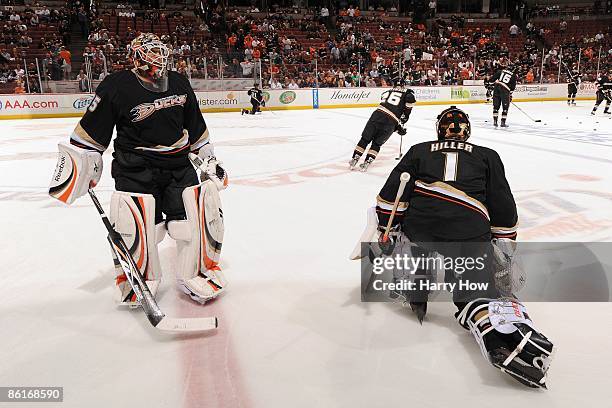 Jean-Sebastien Giguere and Jonas Hiller of the Anaheim Ducks warm up against the San Jose Sharks during Game Three of the Western Conference...