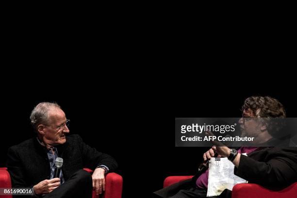 Film director Michael Mann speak with Mexican film director Guillermo del Toro during a panel discussion on October 15, 2017 in Lyon, during the 9th...