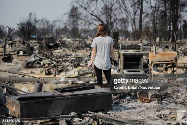 Margaret Curzon looks out at the destruction caused by the Tubbs fire while holding items of emotional importance salvaged from her childhood home in...