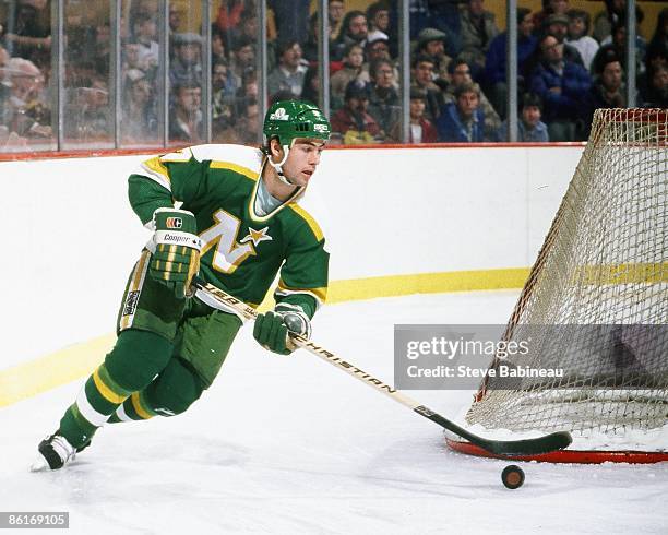 Neal Broten of the Minnesota North Stars skates with puck against the Boston Bruins at Boston Garden.